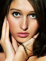 Green-eyed model with alluring face and puffy, round breasts.